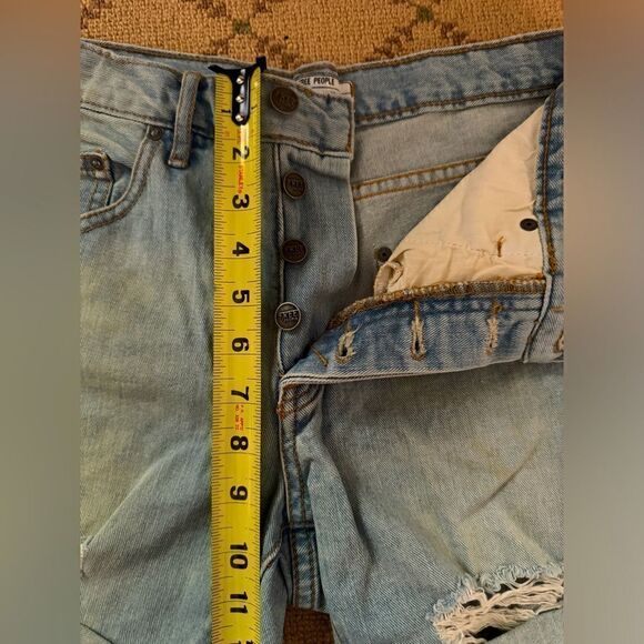 Free People distressed medium wash denim button fly cuffed shorts. 25 - Picture 4 of 12